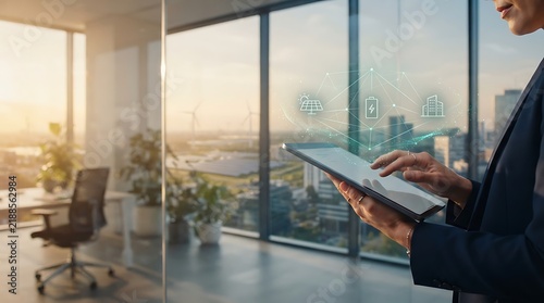 Business professional using a tablet with an energy grid hologram in an office