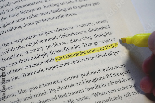 Post-traumatic stress word highlighted in a book page.
