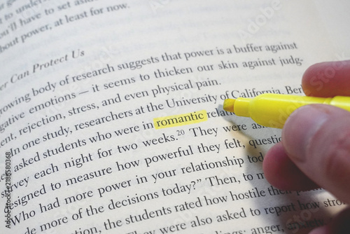 Romantic word highlighted in a book page.