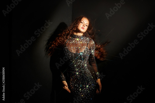 Obraz na płótnie Confident woman with flying hair in a crystal gown, female strength and self confidence concept