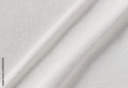 Fotografie Close-up of elegant white fabric draped with soft folds and subtle texture, crea