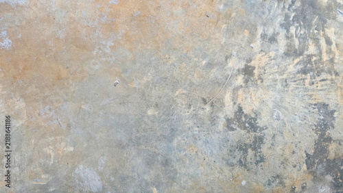 Distressed concrete floor texture background with warm yellow tan patina and weathered grey polished cement surface pattern empty vintage industrial floor slab for product mockup copy space backdrop.