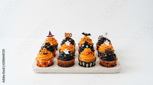 Delicious Halloween Cupcakes with Orange and Black Frosting Decorated with Ghosts Bats and Pumpkins