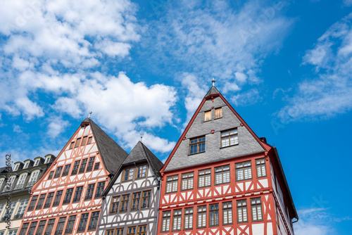 Traditional half-timbered buildings at Römerberg in Frankfurt Germany show colorful gabled facades and repeating windows under a bright sky