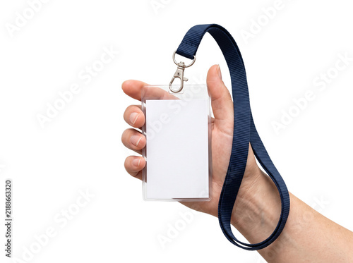 Hand holding blank plastic id card badge holder with dark blue neck lanyard.