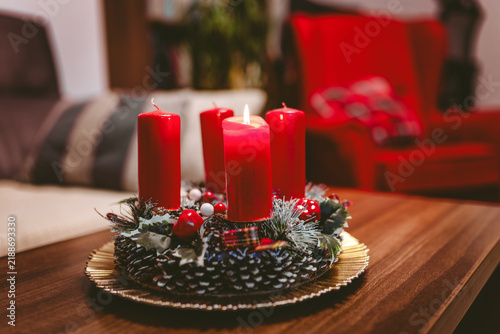 Konstfotografi Christmas advent centerpiece with one burning red candle in cozy living room