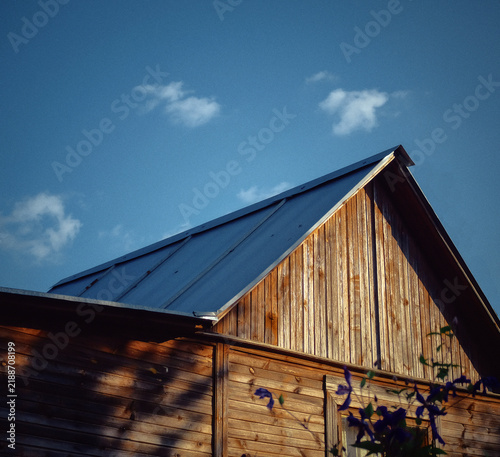 Fotografie Roof and part of facade of an old Russian wooden village house building