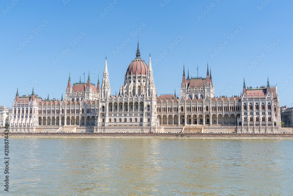 Obraz premium The neo-Gothic building of the Hungarian Parliament on the banks of the Danube in Budapest