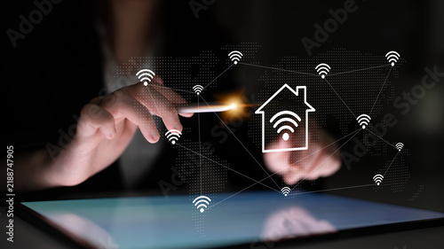 Konstfotografi A person is using a smartphone to manage smart home features, with digital connectivity symbols floating around, illustrating modern technology integration in daily life