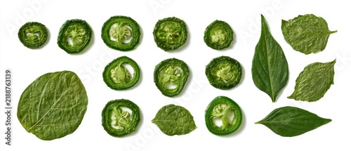 Set of dried green jalapeno slices and pressed pepper leaves, flat lay, pure white background