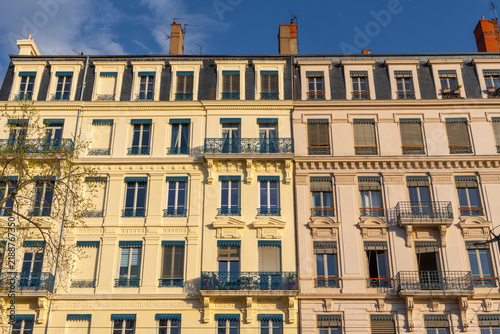 Classic European apartment buildings with ornate balconies and mansard roofs. Lyon