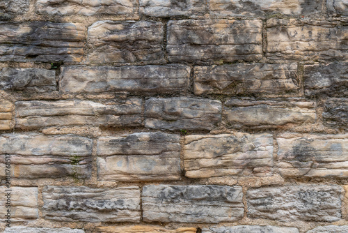 Rough textured stone wall with varied colors and irregular shapes
