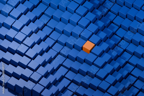Фотография Unique orange cube standing out among blue blocks