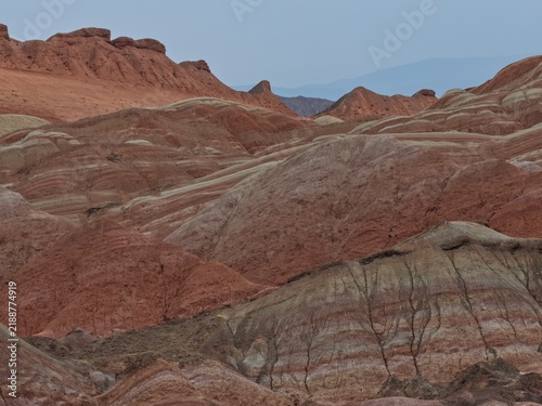 Photography Colorful Zhangye Danxia mountains in Gansu, China, featuring layered rainbow rock formations, dramatic desert scenery and striking geology in a famous Danxia geopark