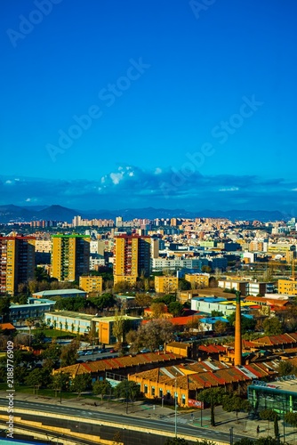 Cityscape with colorful buildings and a smokestack