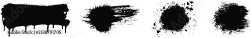 Set of four artistic black ink spray paint splatter elements isolated on white background