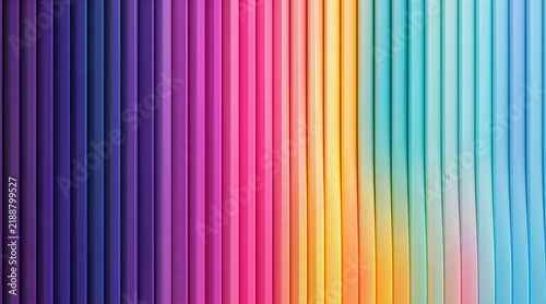 Rainbow colored pencils arranged in a vibrant gradient stripe pattern. Art and design background