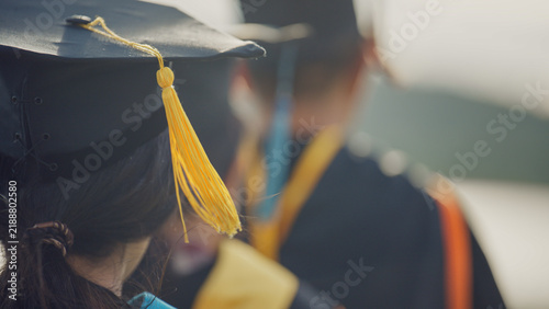Graduates Raising Graduation Caps and Diplomas in Celebration
