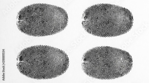 Four black fingerprints isolated on white background.