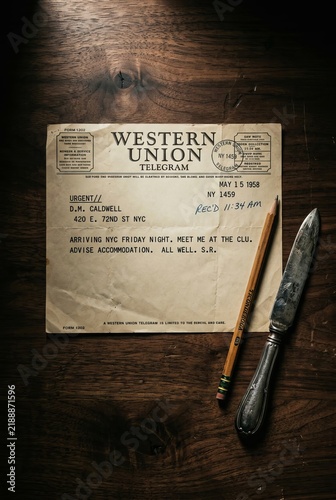 Vintage Western Union Telegram on a Rustic Wooden Table with a Knife and Pencil.