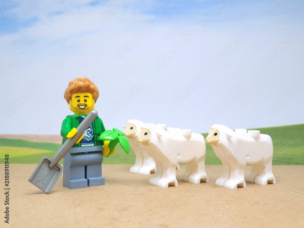 Fototapeta premium Indonesia - November 23, 2023 : Mini toy figure of lego at table with blurred background. Farmer concept design.