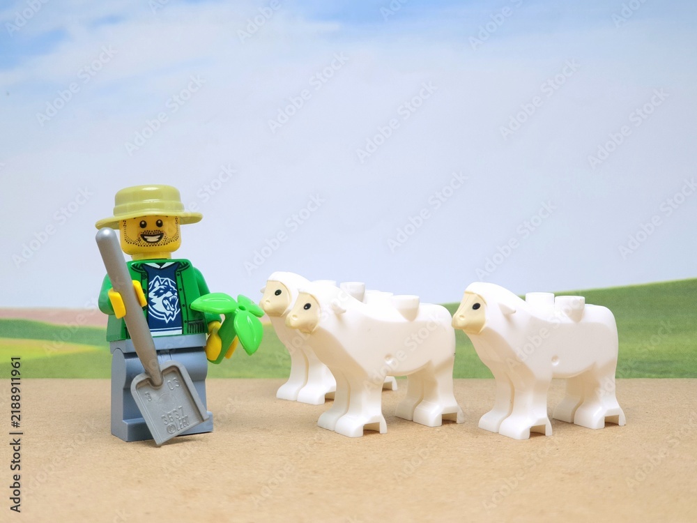Fototapeta premium Indonesia - November 23, 2023 : Mini toy figure of lego at table with blurred background. Farmer concept design.