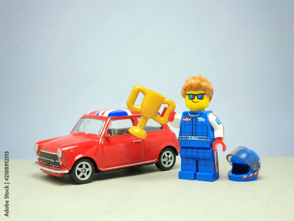 Fototapeta premium Indonesia - November 29, 2023 : Mini toy figure of racing car at table with blurred background. Toy photography concept design.