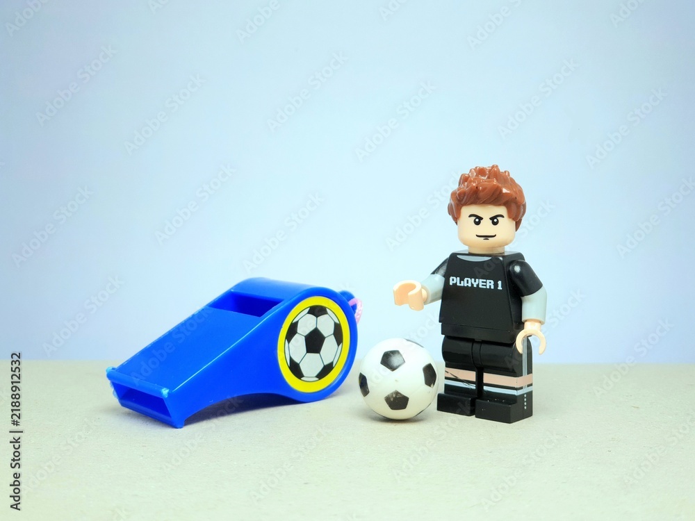 Fototapeta premium Indonesia - March 20, 2024 : Mini toy of action figure at table with blurred background. Toy photography concept. Football player concept design.