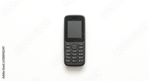 Basic Mobile Phone: A simple, black mobile phone with a keypad and a blank screen, isolated on a plain white background, representing straightforward communication.