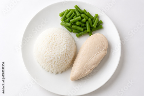 Flavorless bland diet meal, plain white plate with steamed rice, boiled chicken breast and unsalted green beans