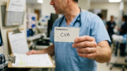 Doctor Holding A Card With Cva Diagnosis In A Medical Setting