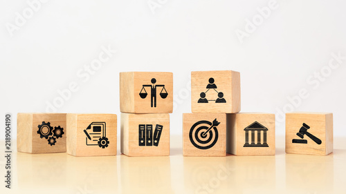Wooden cube with ethics symbol. Represents corporate responsibility, integrity, and compliance in business practices.