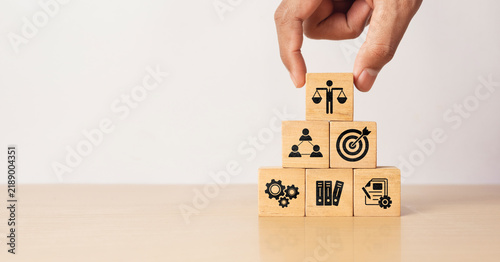 Bild auf Leinwand Hand holding wooden block with Ethical icons, business ethics and corporate comp