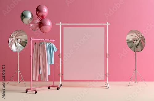 Pink backdrop, balloons, clothing rack, and studio lights setup