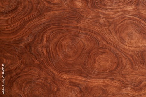 Richly patterned warm-toned wood grain with swirling, organic, abstract shapes