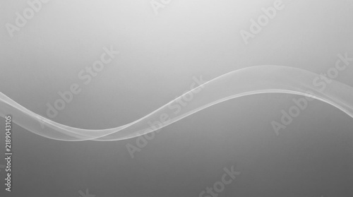 Abstract grey and white flowing wave smoke background.