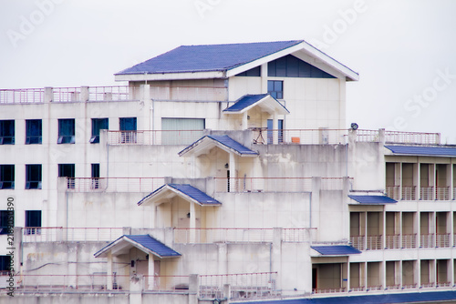 Cuadro en lienzo Exterior view of a multistory residential building with balconies and blue roofs