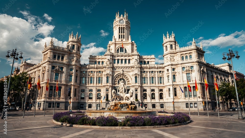 Fototapeta premium Palacio de Comunicaciones building stands proudly under a blue sky in Madrid.