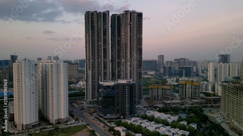 Aerial shot of tallest skyscrapers in South India under construction in Hyderabad cityscape at sunset.