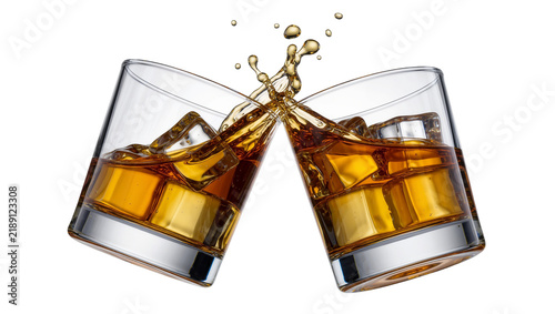 Фотография Two whiskey glasses clinking with amber liquid and ice cubes, isolated on transp
