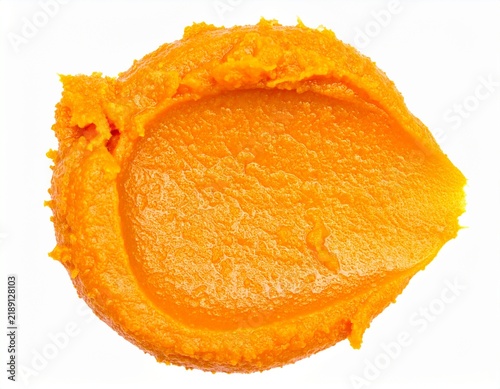 Fresh pumpkin puree spread on clean white background
