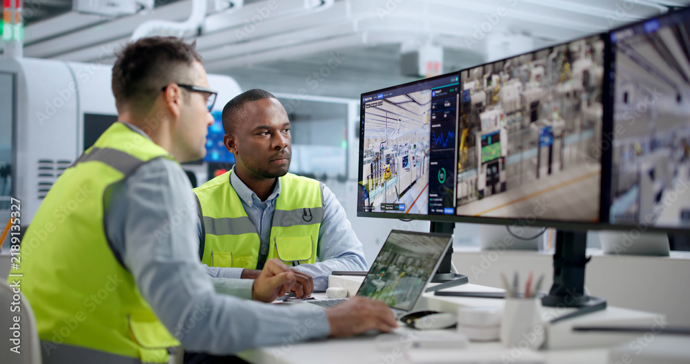 Fototapeta premium Engineer Monitors Automated Manufacturing Line