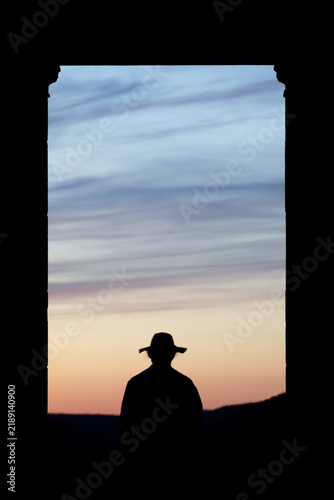 silhouette man with a hat in the window of the viewpoint with the evening blue sky-Decin viewpoint Elbe guard