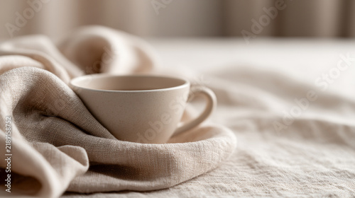 Minimal Beige Ceramic Cup Nestled in Soft Linen Fabric