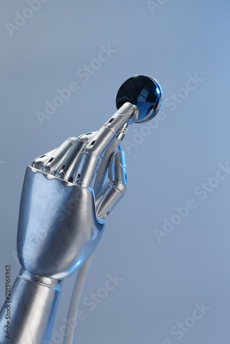 Metallic Robot Arm with Blue Sphere Head Against Sky