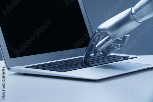 Robot Hand Typing on Laptop Keyboard - AI Technology Innovation