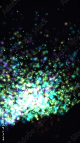 Glowing glitter particles on black background, shimmering bokeh light effect, abstract magical dust motion for festive video overlays