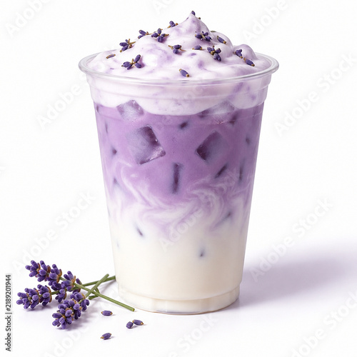 Iced lavender latte with purple foam topping and fresh lavender sprigs in a clear plastic cup, isolated on white background