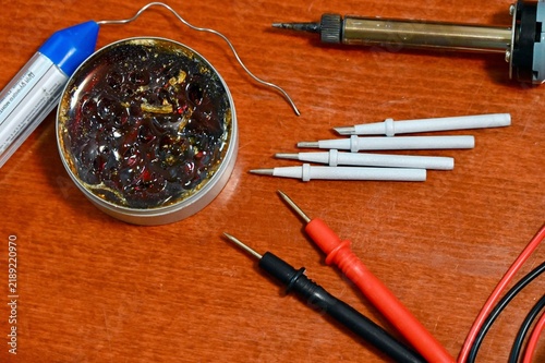 Obraz na plátně Flat lay of various soldering tools, rosin flux, and multimeter probes on a wood