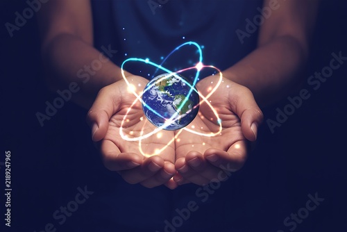 Human Hands Holding Glowing Atom Planet Earth Energy Concept Image
